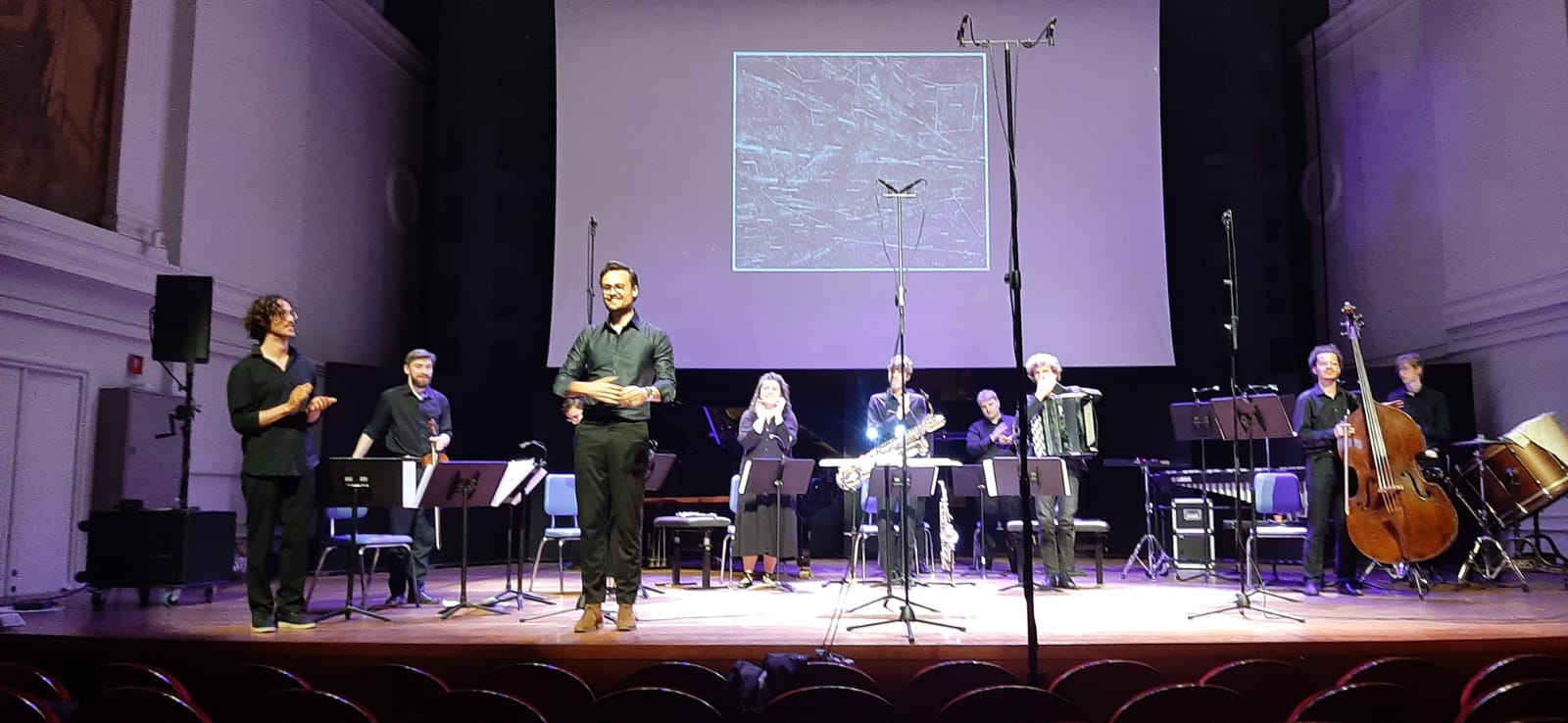 the orchestra and the composer takes in the applause after the second performance of Omphalos