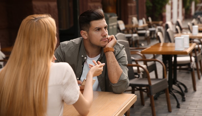 Man ignoring his date