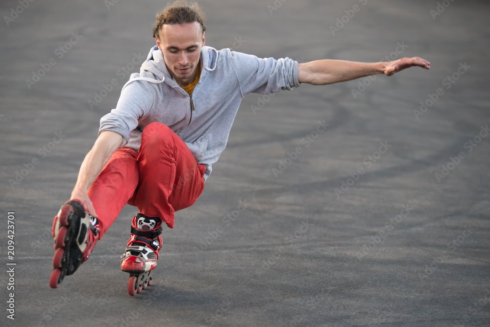 MAN ROLLER SKATING