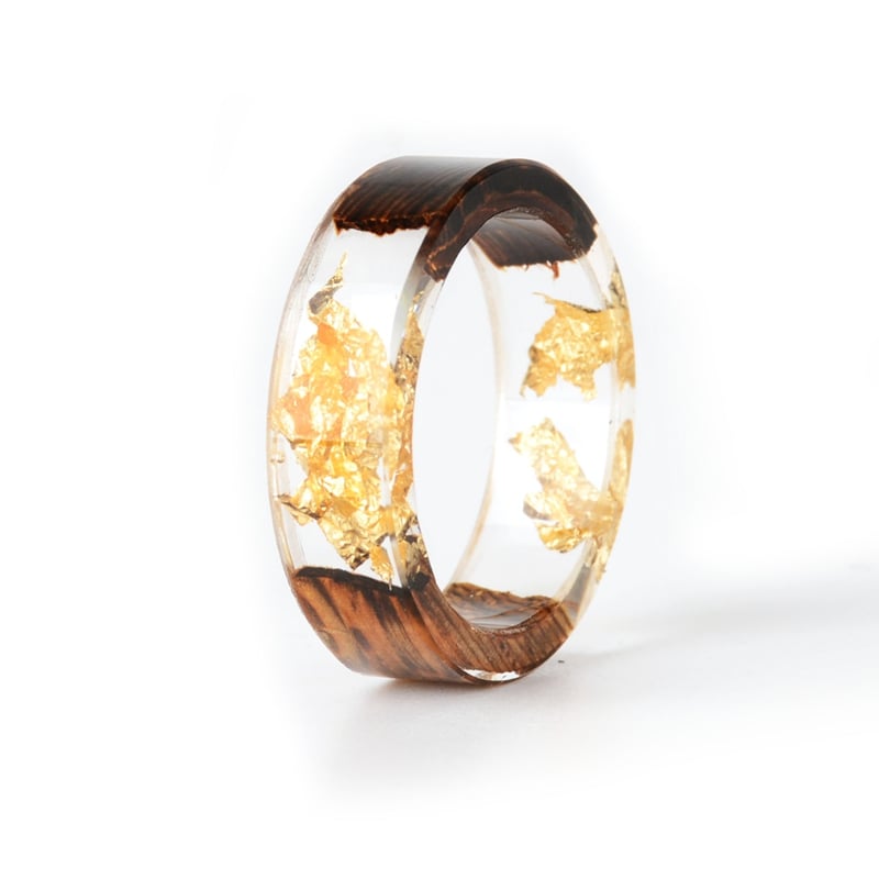 This stunning handmade Wood Resin Ring combines the natural beauty of wood and transparent epoxy resin to create a truly unique piece of jewelry. Featuring delicate, real dried flowers embedded within the resin, this elegant love ring is perfect for weddings, anniversaries, or as a meaningful gift for someone special. Its fashionable 2019 design adds a touch of timeless sophistication, making it an ideal accessory for any occasion. Lightweight, durable, and beautifully crafted, this ring is designed for women who appreciate artisan craftsmanship and nature-inspired elegance.