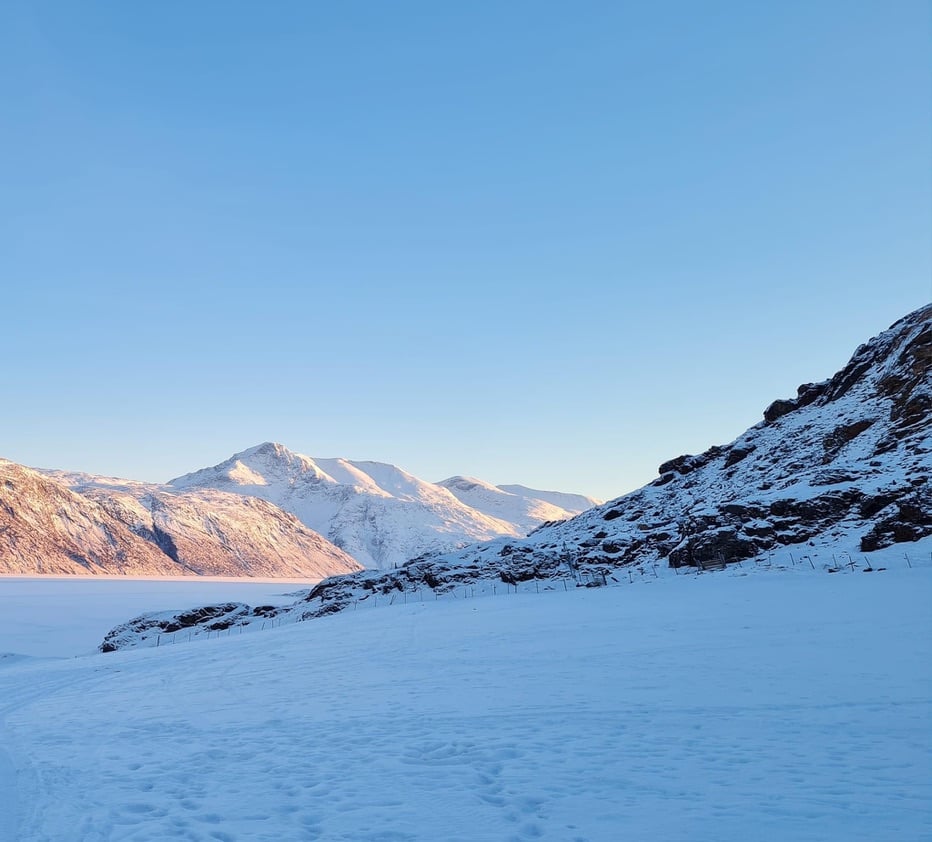 Greenlandic winter landscape with snow and sunshine on maintains