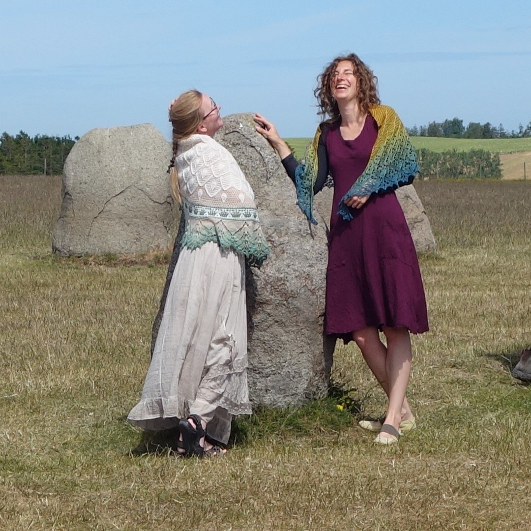 Nim Teasdale (right) and Anne-Lise Maigaard wearing knitted shawls at Iron Age megalithic monument