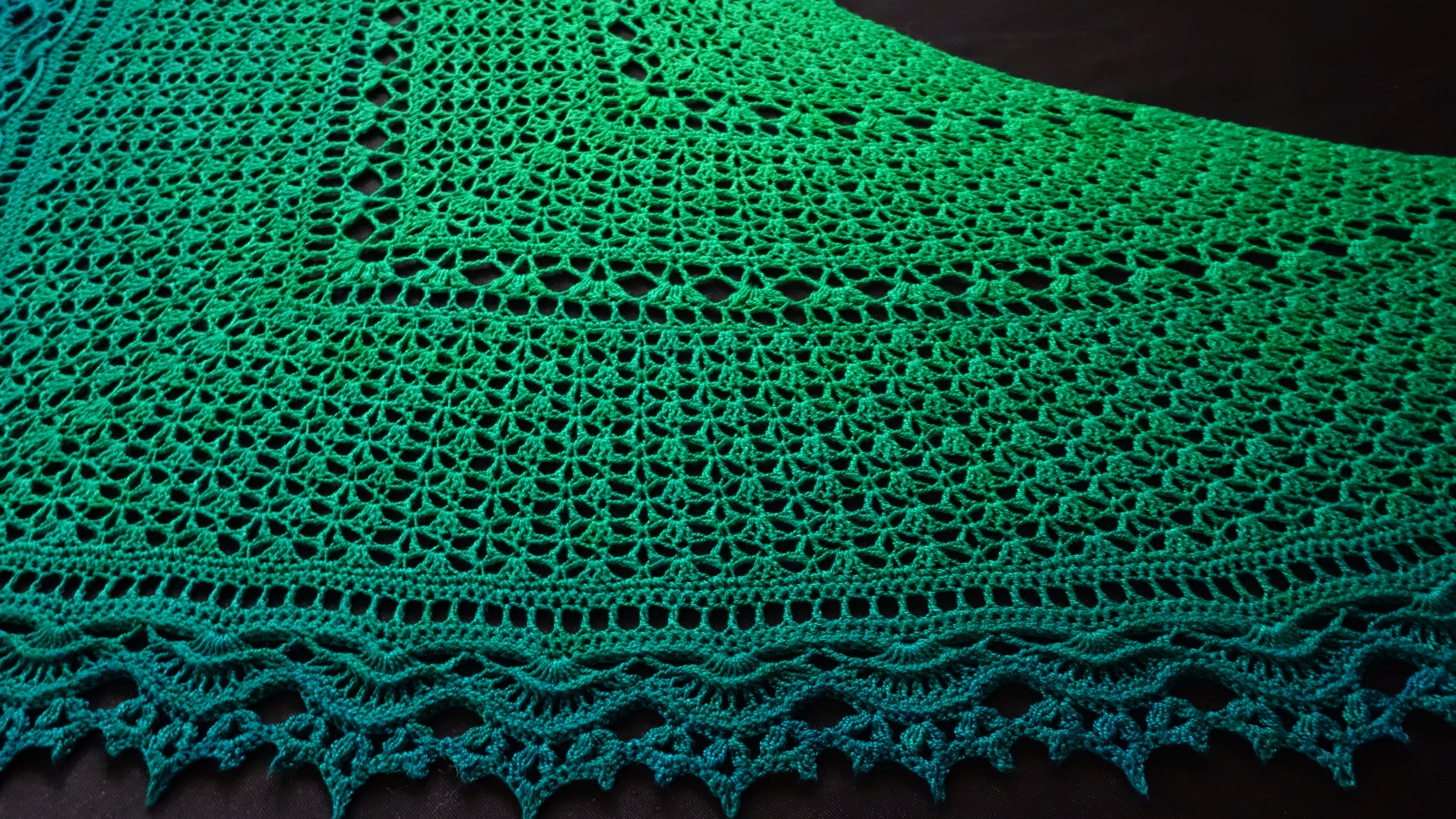 Crochet lace shawl in a vibrant green gradient