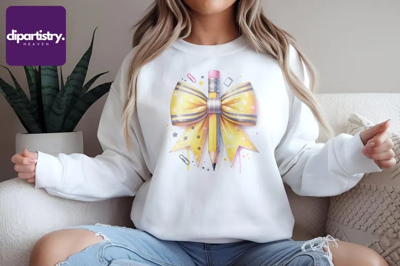 White sweatshirt featuring a yellow bow and pencil sublimation design, perfect for back-to-school and coquette-themed digital downloads.