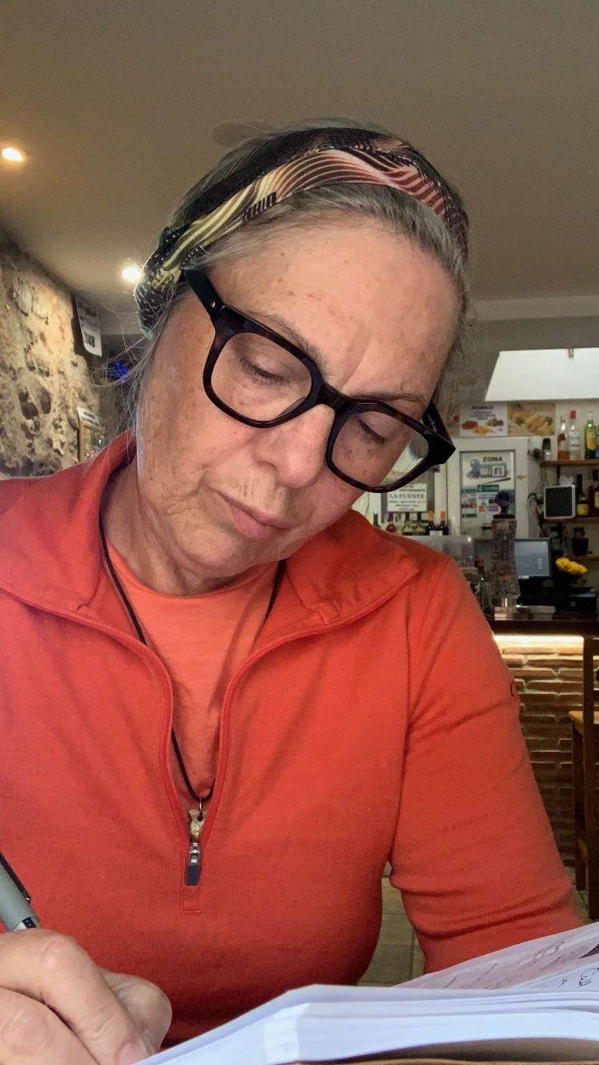 woman writing in a cafe