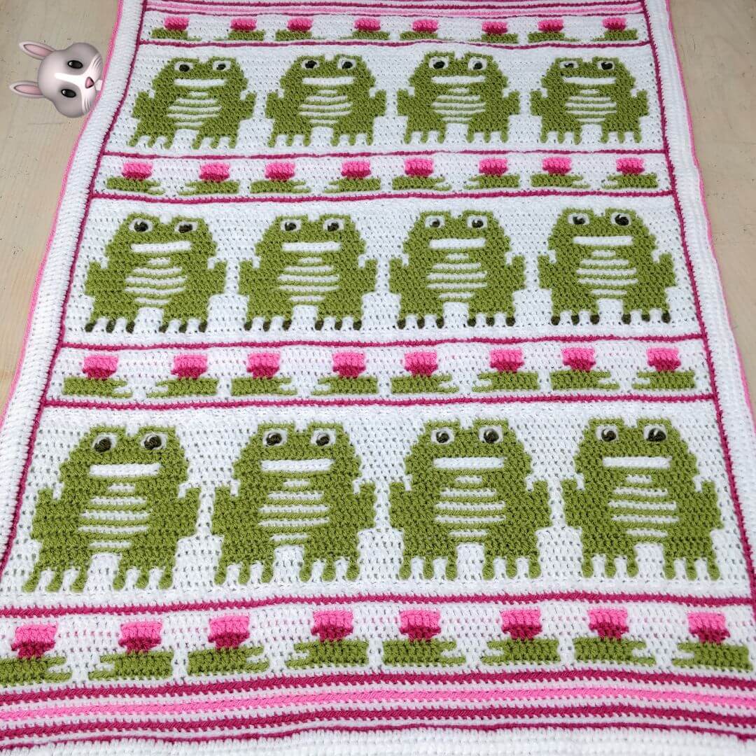 Crochet blanket showing frogs arranged in rows with lily pad strips in between