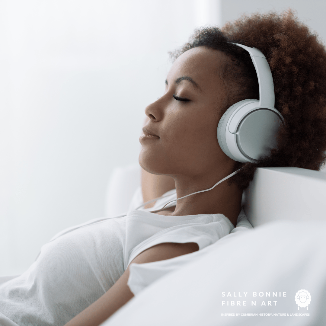 black woman listening to podcast using headphones