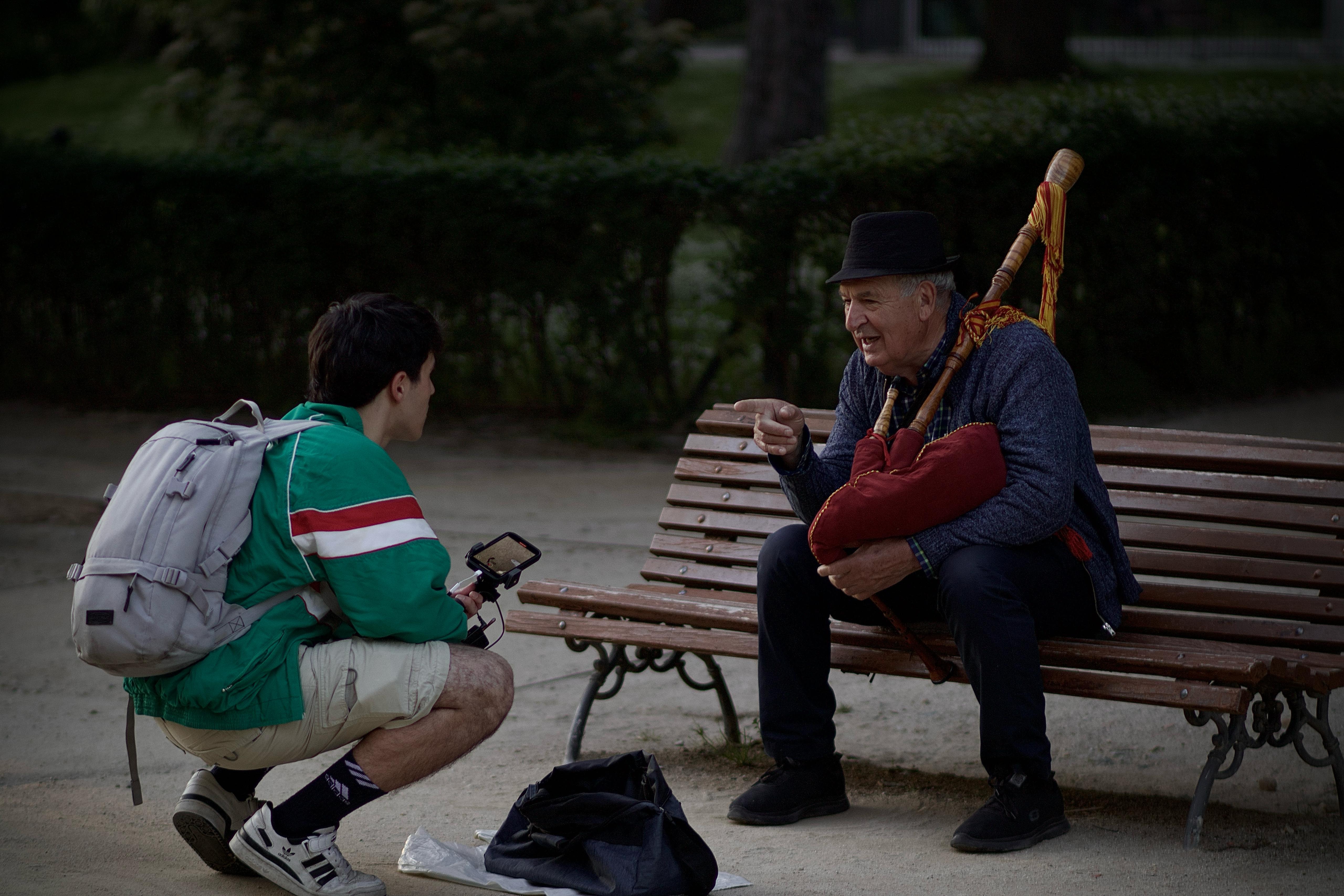 Two people in Madrid’s Retiro Park, natural Spanish day to day scene for city culture guides.