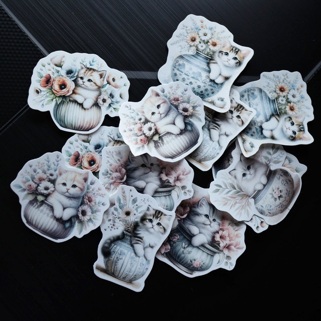 cat in a pot with floral stickers