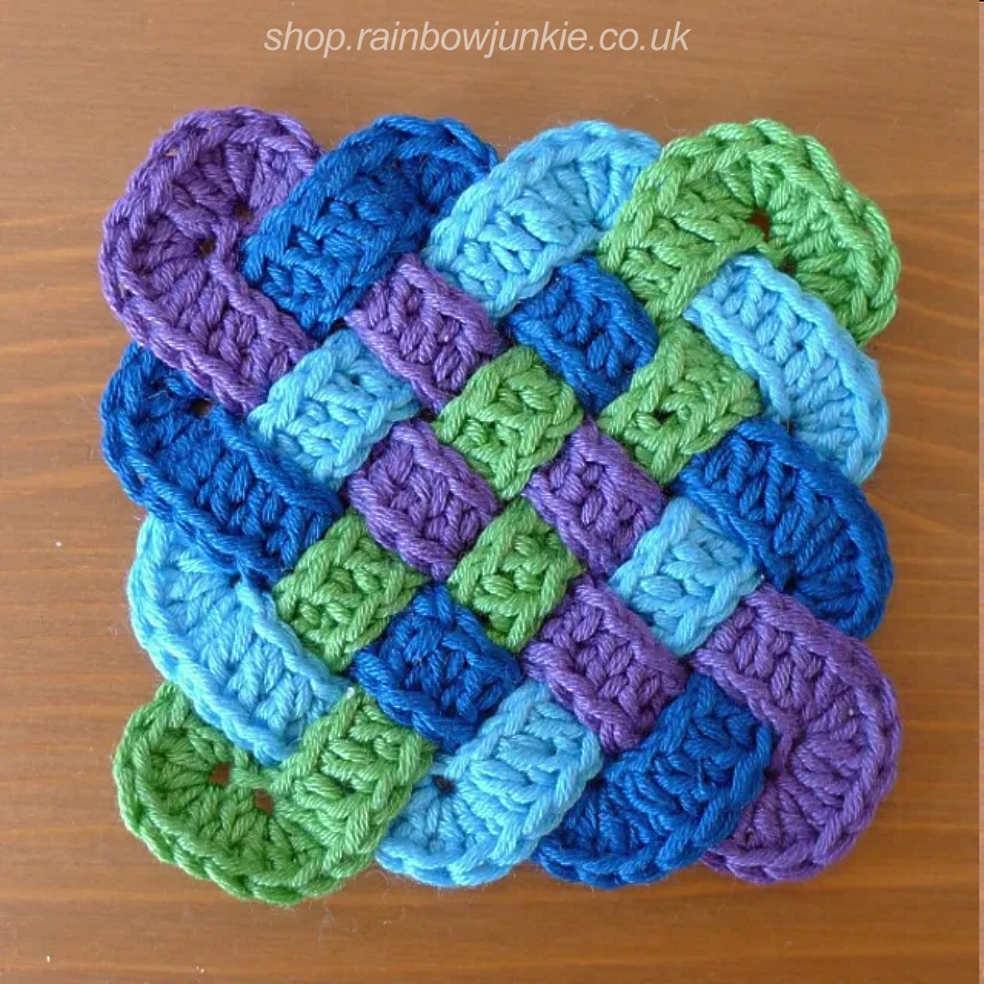 Four part Celtic plaitwork coaster in purple, dark blue, blue and green.