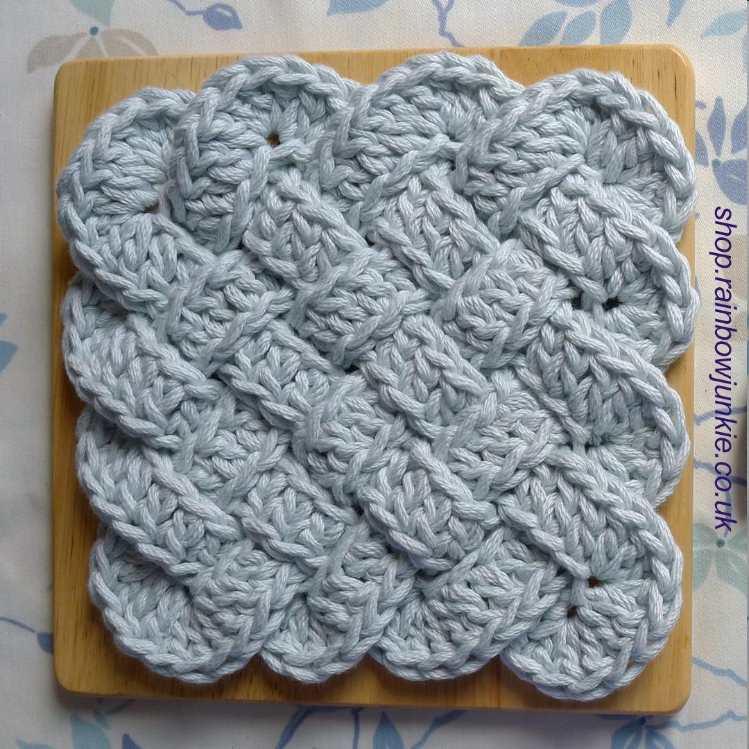 Pale blue plaiwork Celtic coaster made in super chunky yarn to use as hot pad.