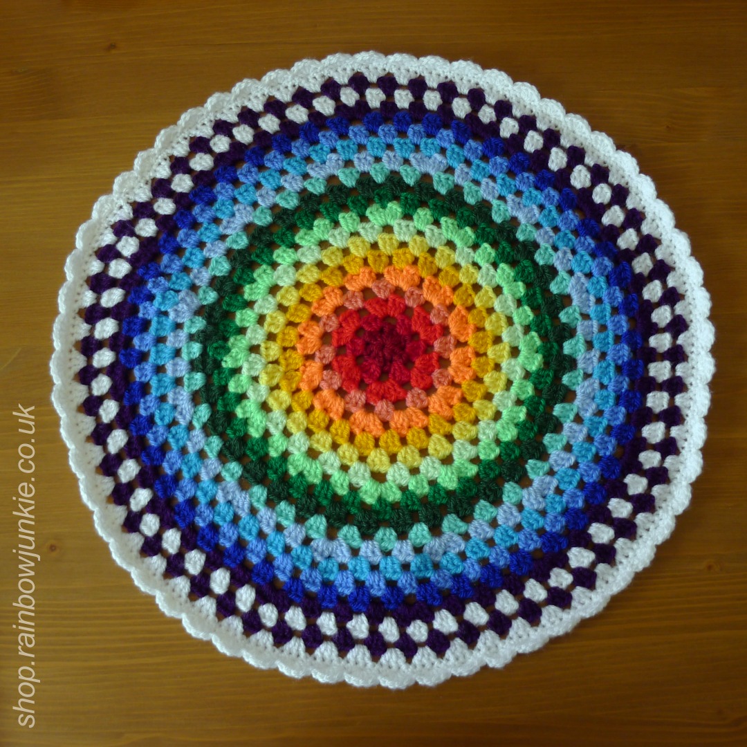 Rainbow granny circle mat on table.