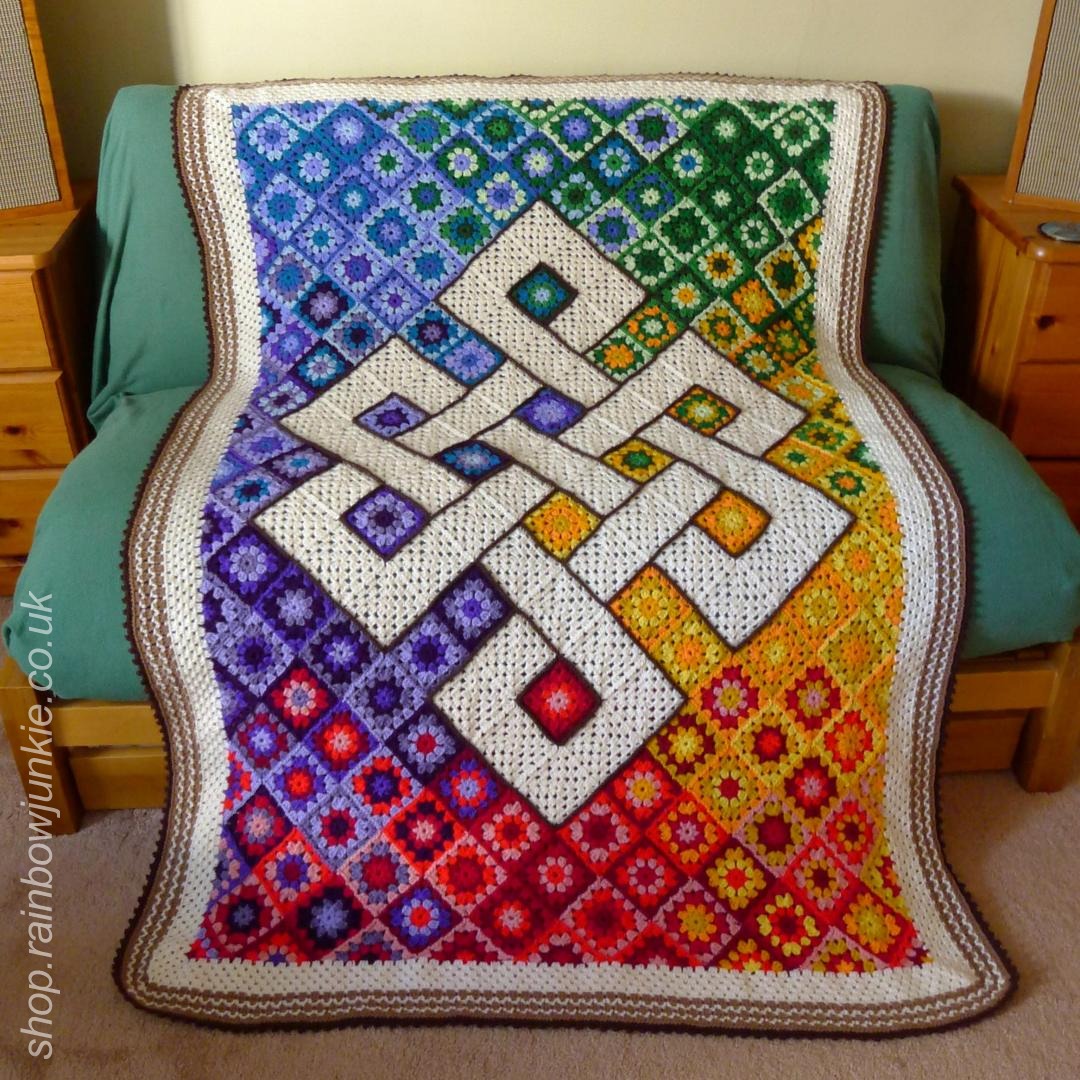 Blanket with rainbow background and Celtic eternity knot in the centre.