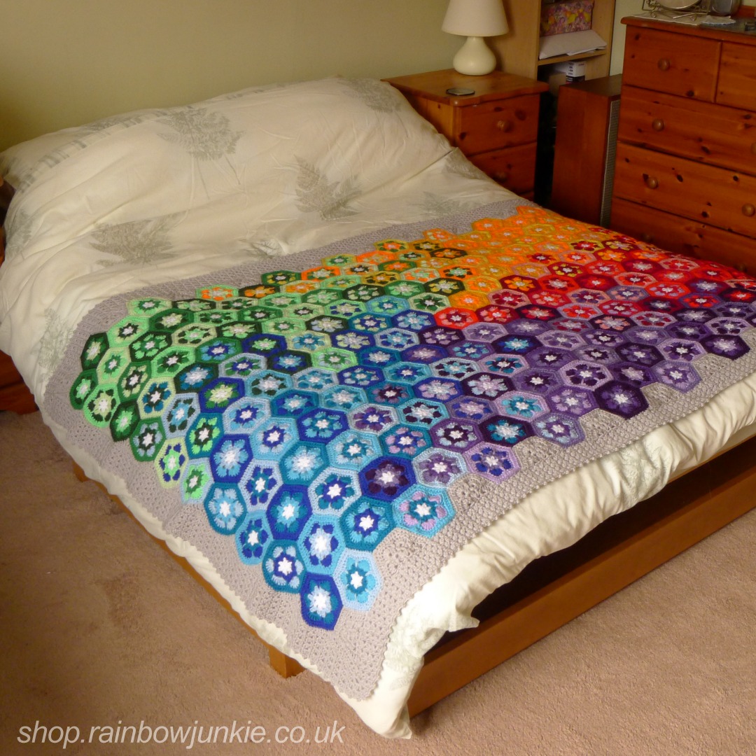 African Snow Flower Blanket across a double bed.