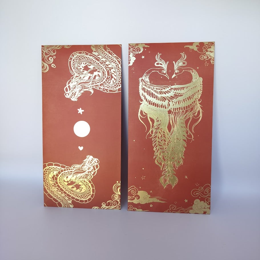 Two red hong baos side by side. The left features two dragons in gold foil, while the right has two phoenixes in gold foil.