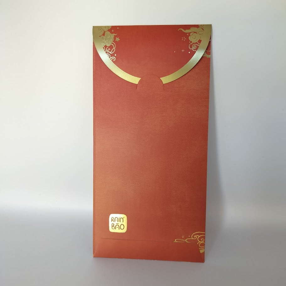 Back of a red money envelope with gold foil trim on the closing flap and a stamped gold logo on the bottom left.