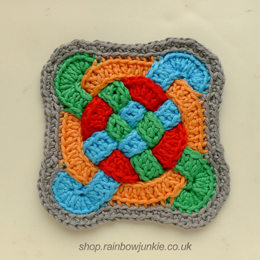 Edged Celtic Coaster in blue, green, orange and red.