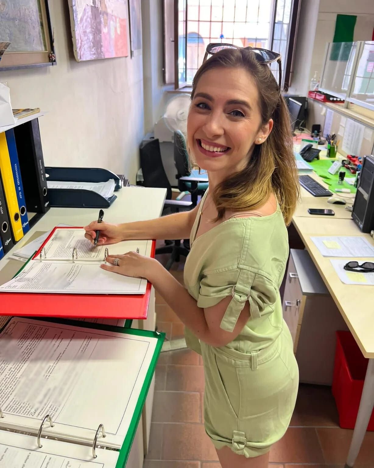 our client Nina signing her papers for her jure sanguinis application