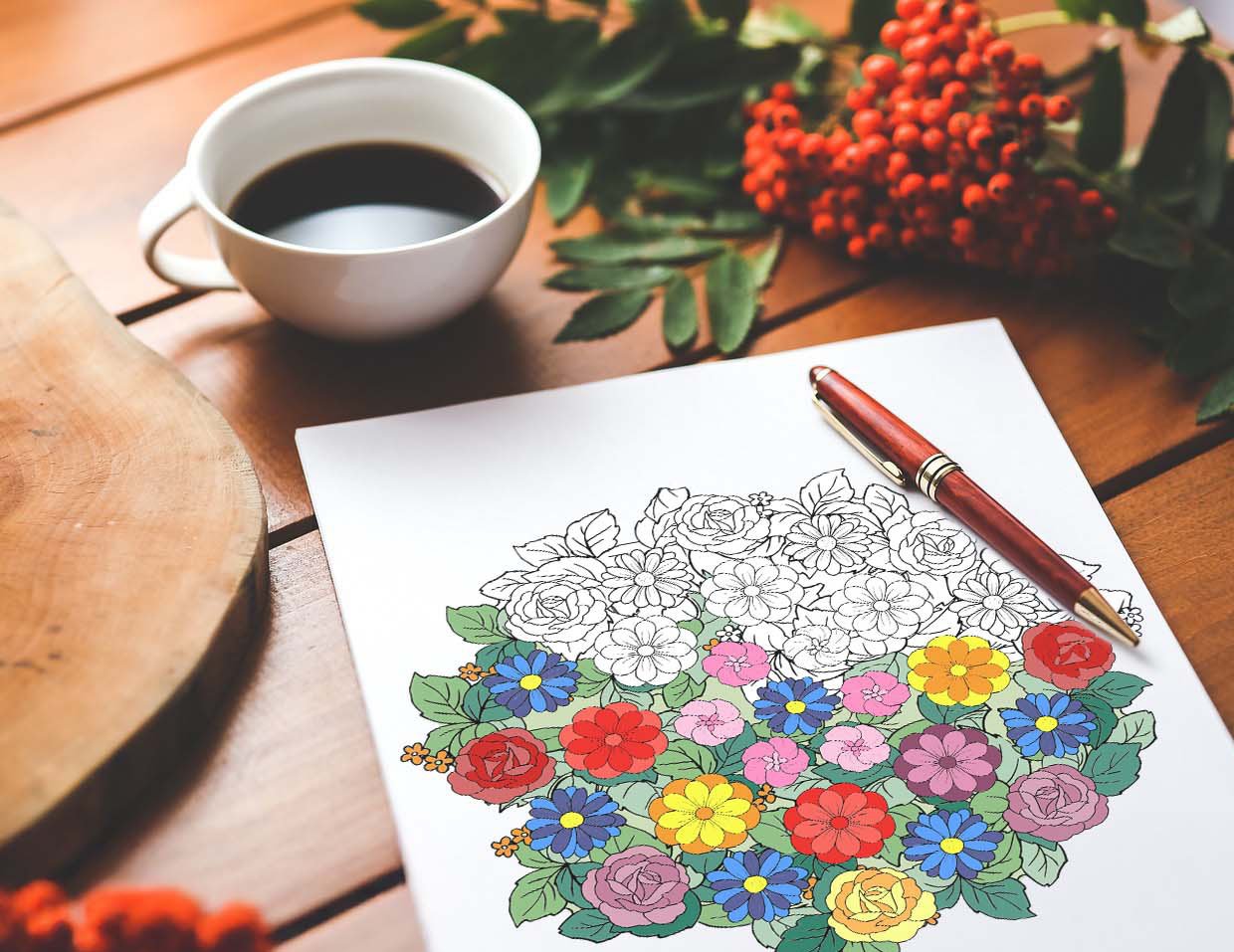 habit tracker flower mandala page on table with pen and coffee cup