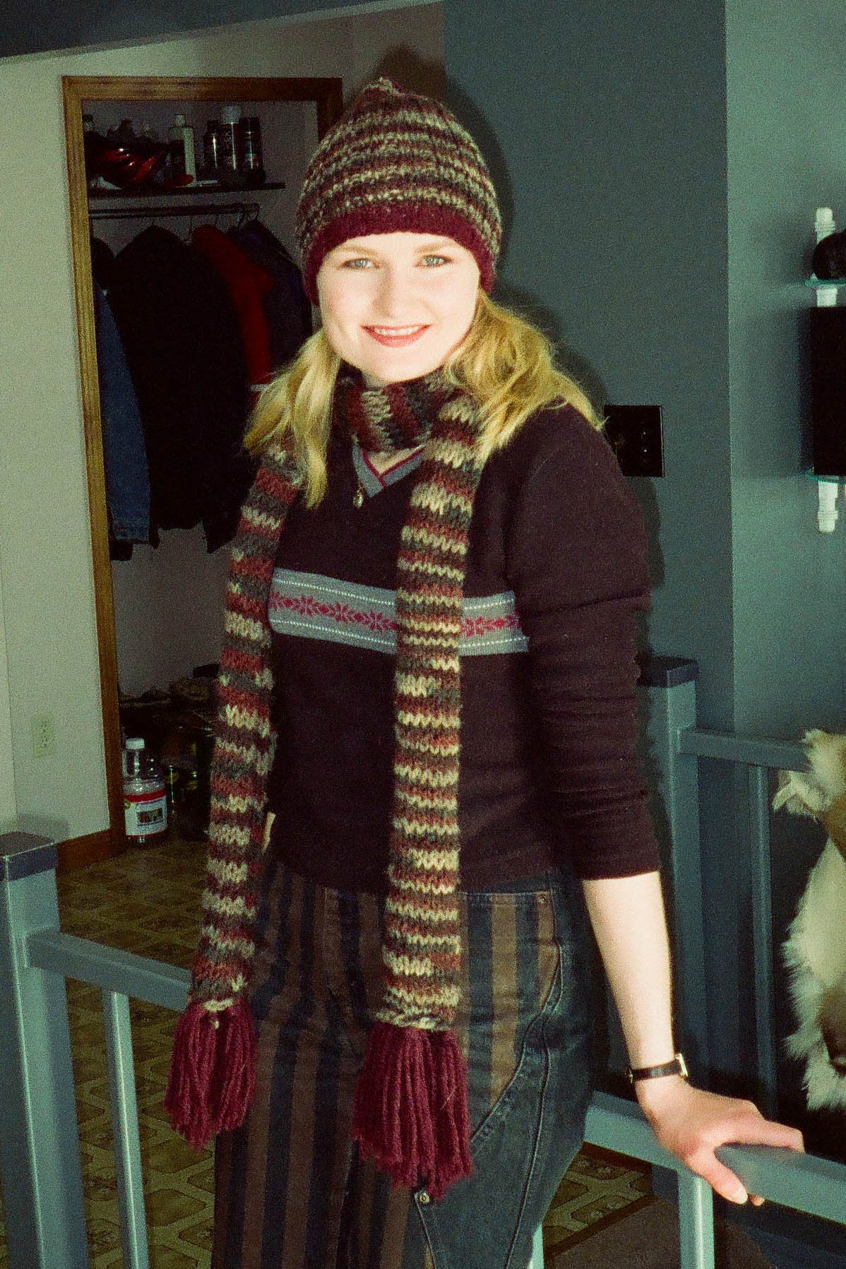 Talena in a long tasselled scarf and pompom beanie.