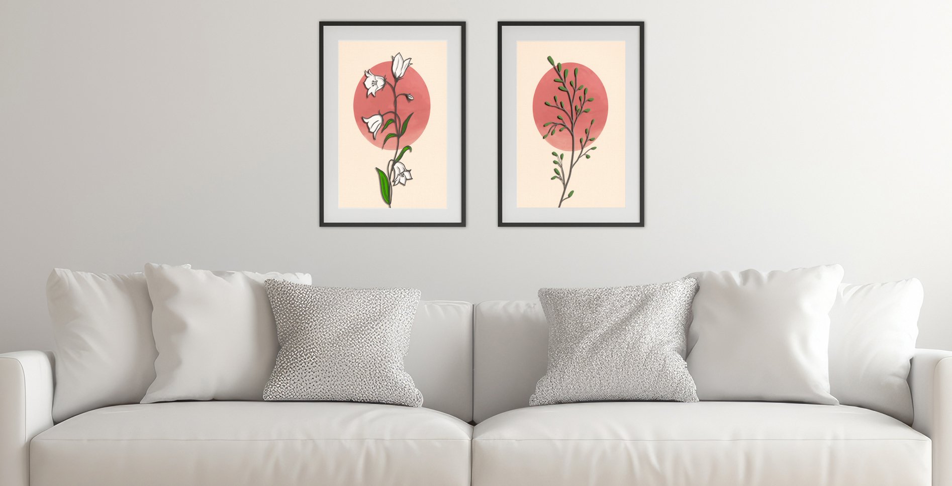 A white living room features two frames of minimalist botanical plants digital art prints that are hanging on the wall above a white sofa.
