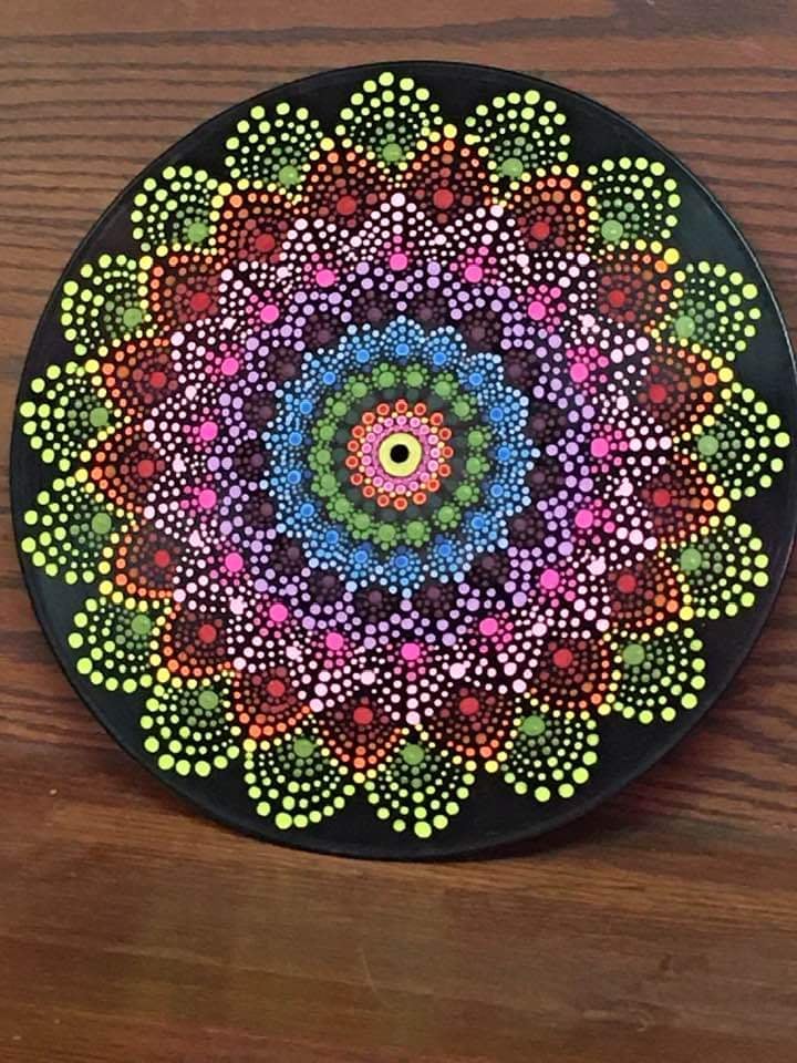 Dot mandala art painted on upcycled vinyl record. Featuring bold neons and intricate radial patterns, this handmade piece transforms a forgotten record into a mesmerizing burst of color and symmetry. A vibrant blend of mindfulness, retro revival, and upcycled creativity.