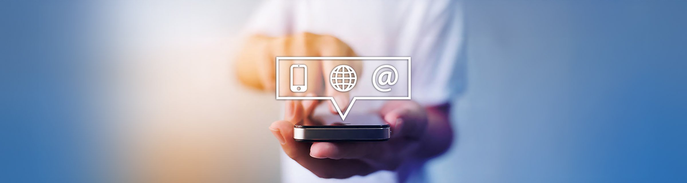 A close-up of a person holding a smartphone, with overlay icons of a mobile phone, a globe, and an email symbol floating above the device, symbolizing communication through phone, internet, and email. The background features a soft gradient of blue and white, creating a clean and modern aesthetic. This image represents how to contact The Creative Guide, emphasizing that, unlike competitors, we encourage people to call and talk to a real human, ensuring personalized and accessible support.