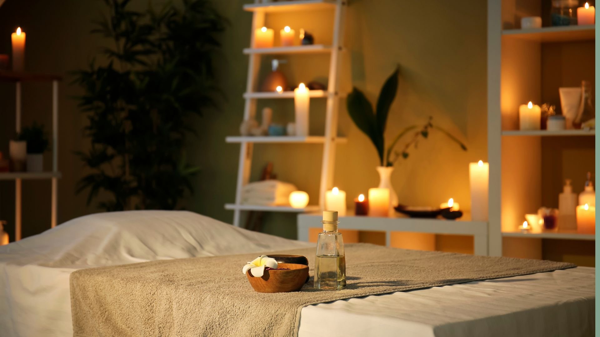 Candle lit treatment room with massage table and Balinese massage oil at Inner Bliss Wellness Space