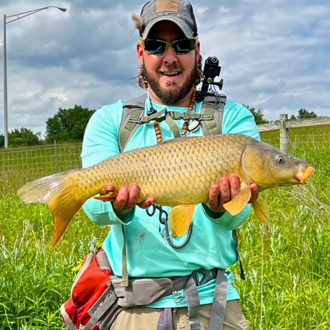 Fly fishing guide Matt Campbell holding an Ohio marsh carp caught on the Carp Vader Dark Hybrid fly.