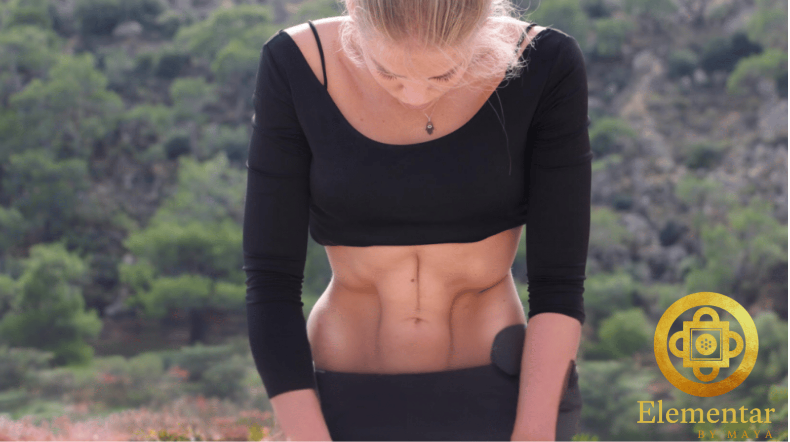 woman practicing nauli kriya abdominal yoga technique outdoors – Elementar by Maya