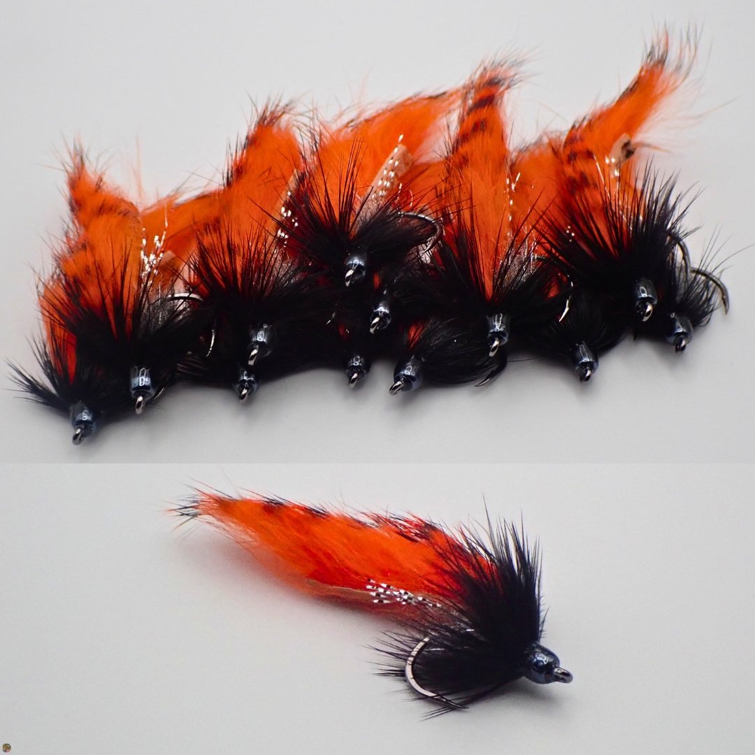Pile of orange and black Cut Zonker streamer flies, tied by The Fly Guy, Matt Campbell.