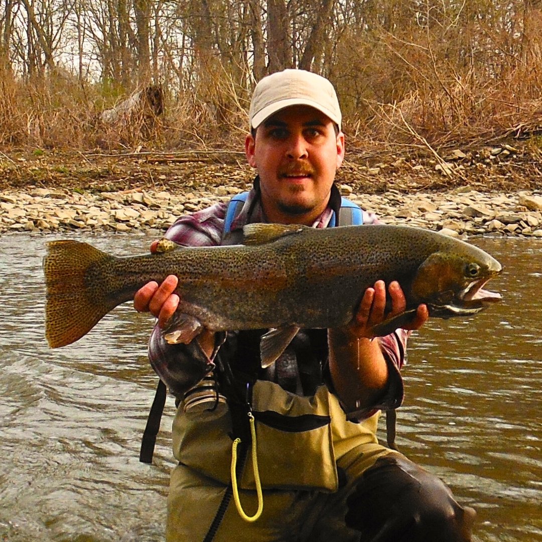 Fly fishing guide Matt Campbell holding a Lake Erie steelhead from the Chagrin River, caught on the Ice Egg fly.