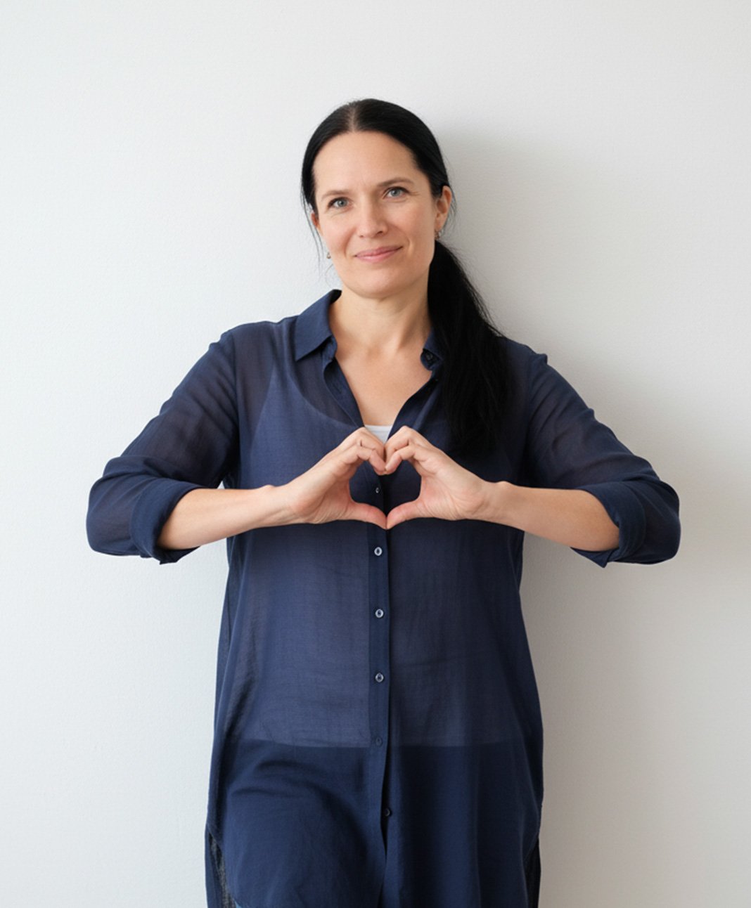 Mette making a heart with her hands in front of her chest