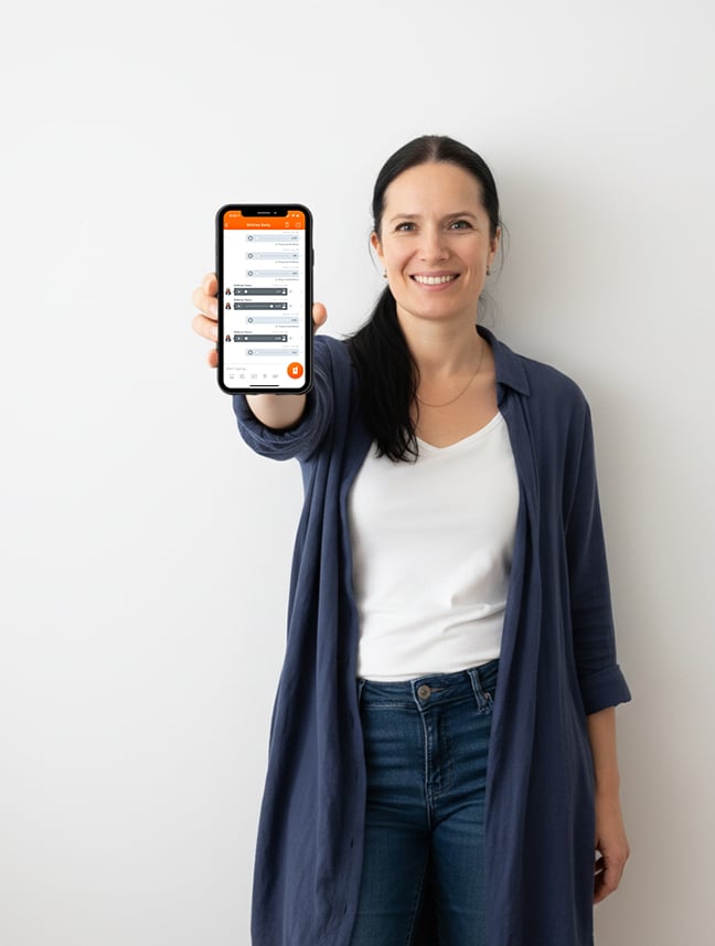 Mette holding up an phone with voxer chat to the camera