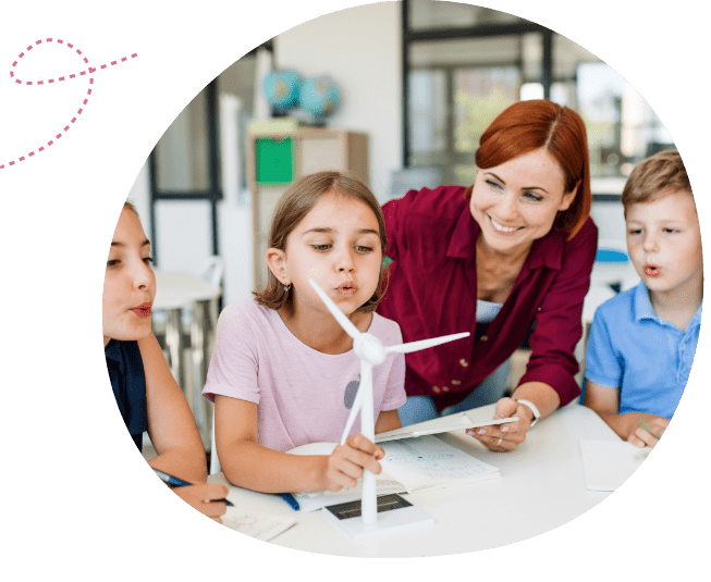 Educator with children experimenting with blowing on windmill