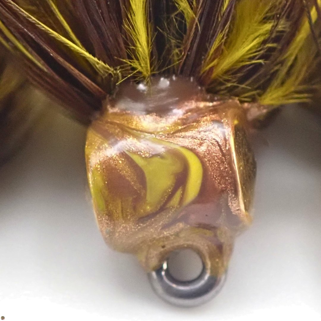 Close-up of the marbled fabric paint head on the Honey Brown Creek Bugger Bass Version woolly bugger fly.