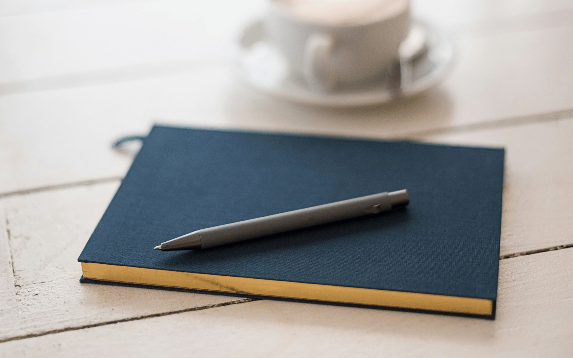 Notebook, pen and coffee — inspiring women over 50 to begin their creative journey