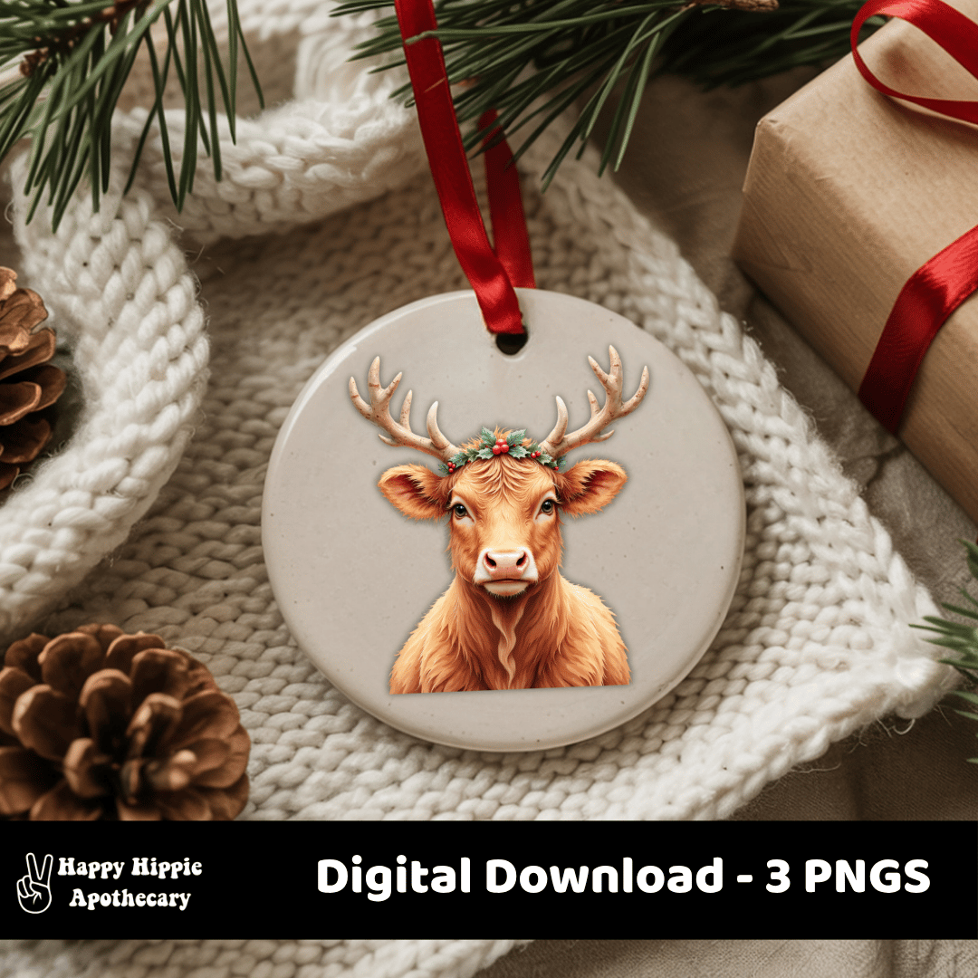 Round ceramic ornament with a Highland cow wearing reindeer antlers and holly, placed among cozy Christmas decor.