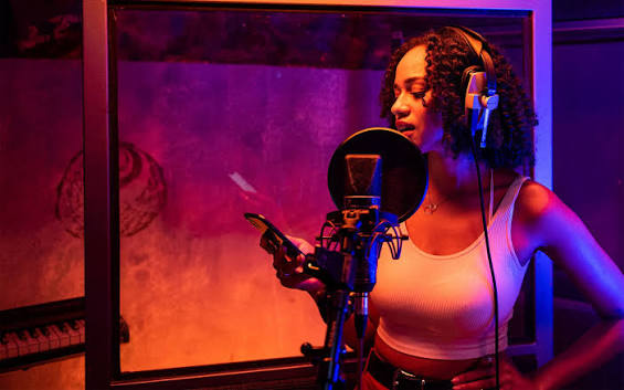 Afrobeats artist in studio expressing emotion during recording session, showing the power of feeling over hype in music promotion.