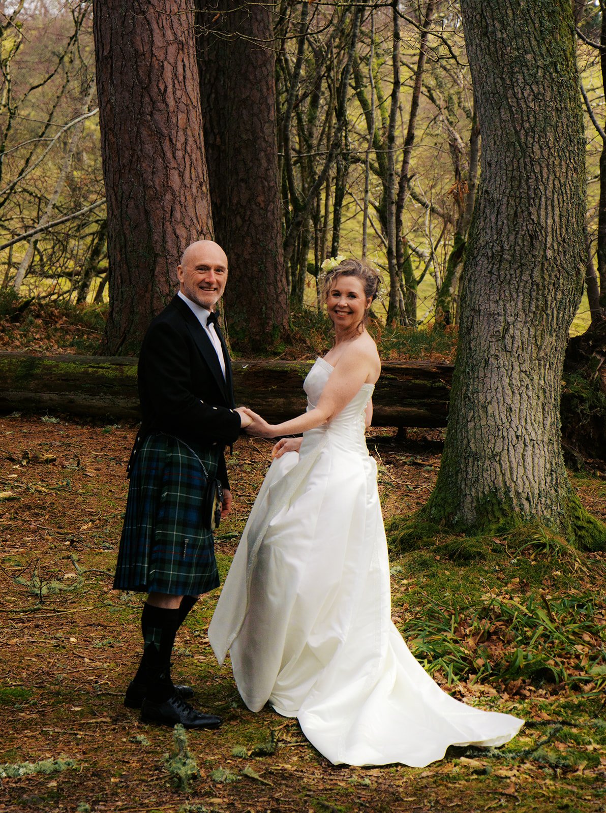 Author Cat Darling and Mr Darling amongst the trees on our Highland elopement