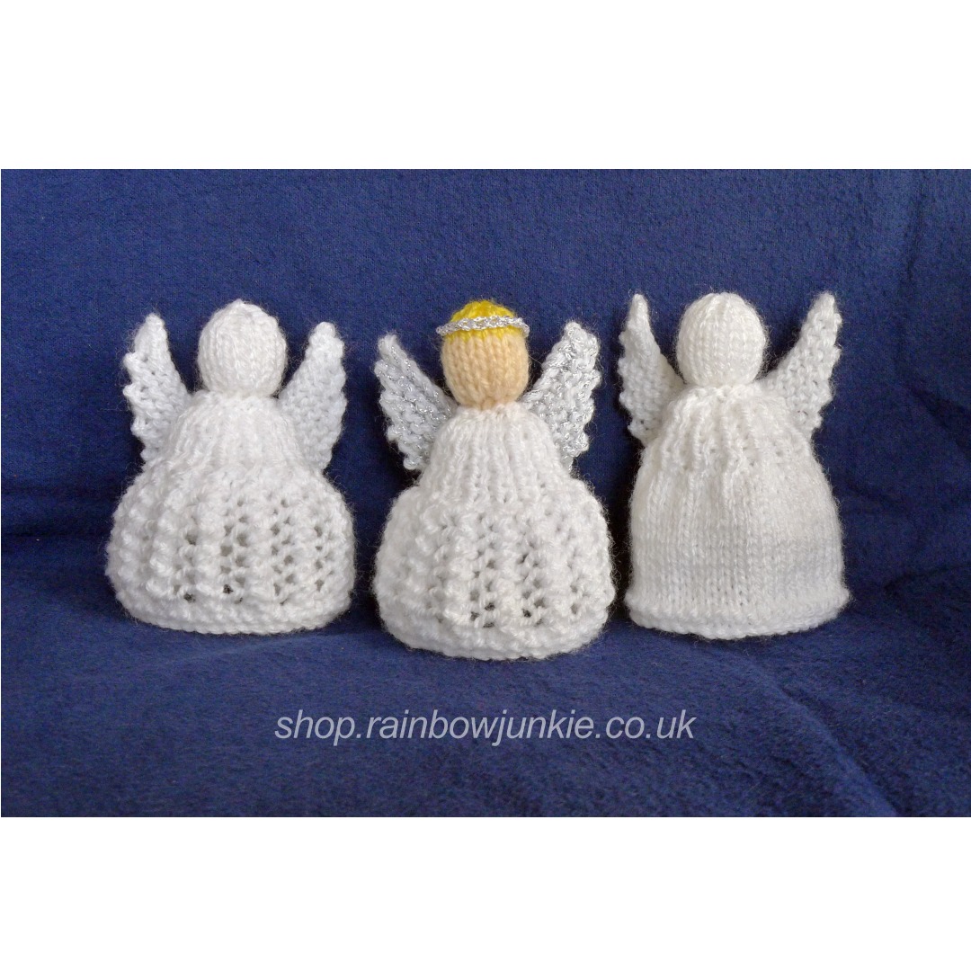 Three different angels in white. One has coloured head. two different types of skirt.