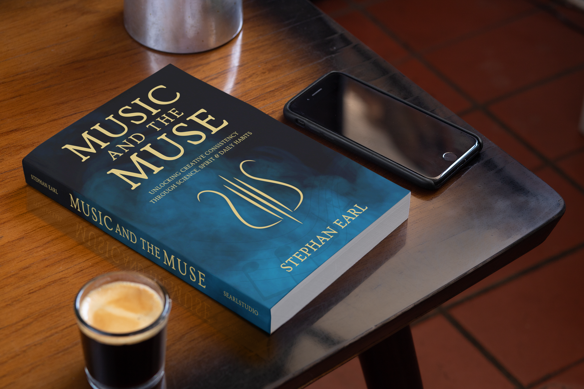 Music and the Muse book in a coffee shop with espresso drink