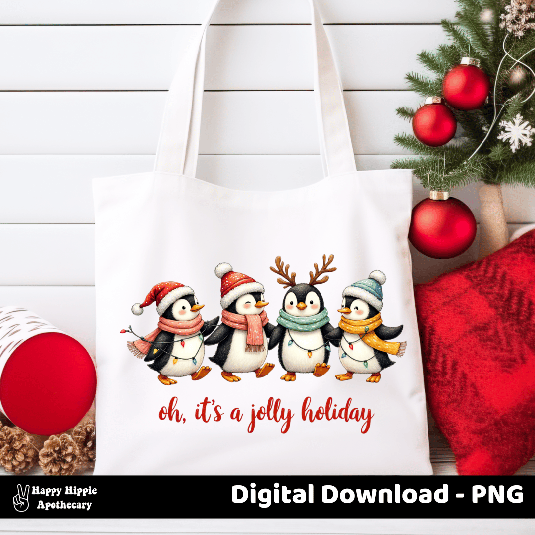 White tote bag featuring penguin Christmas PNG – cute holiday design with lights, scarves, and “Oh, it’s a jolly holiday” quote for sublimation bags