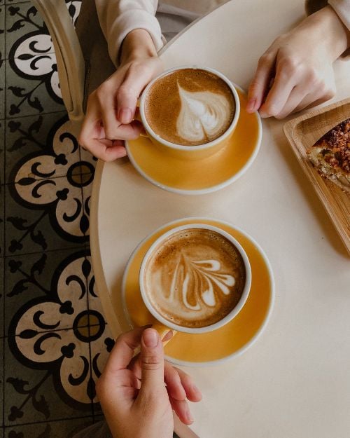Two coffee cups at a café — representing creative support for women over 50 beginning to write