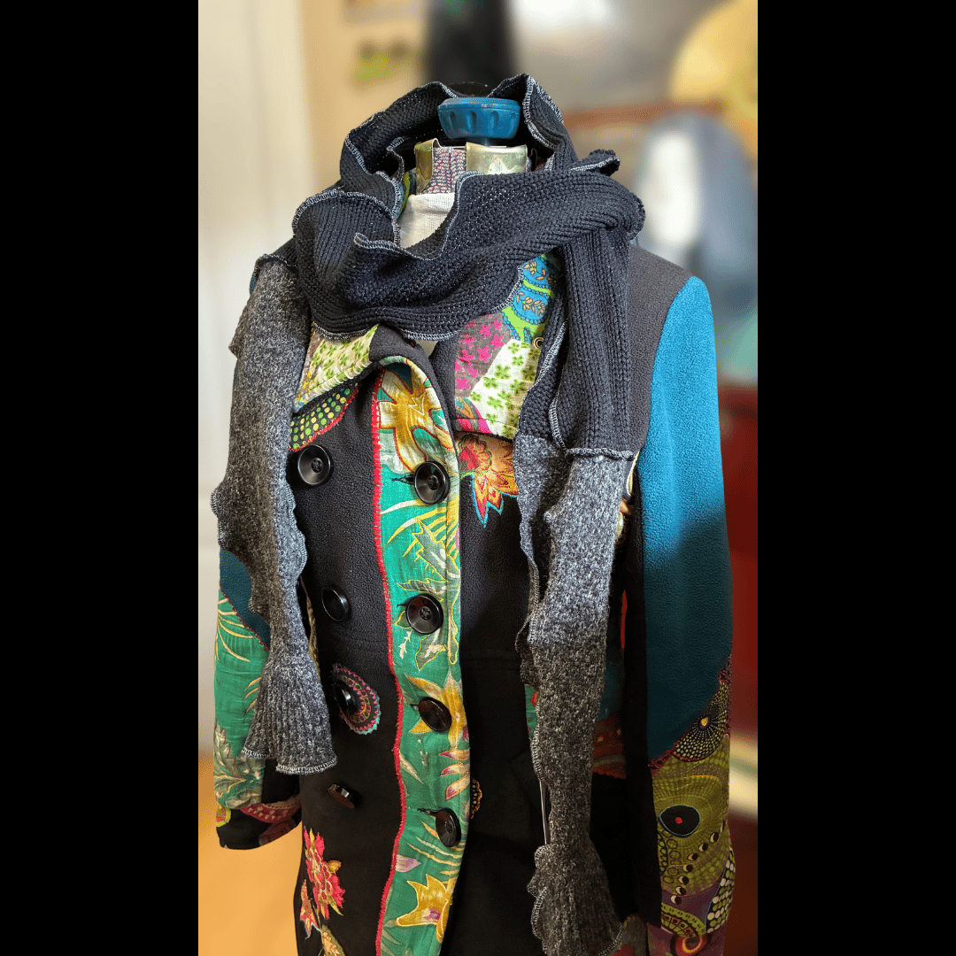 Upcycled scrappy scarf in smoky greys and deep midnight tones, handmade from rescued sweaters with wavy serged edges by What in Narnation.