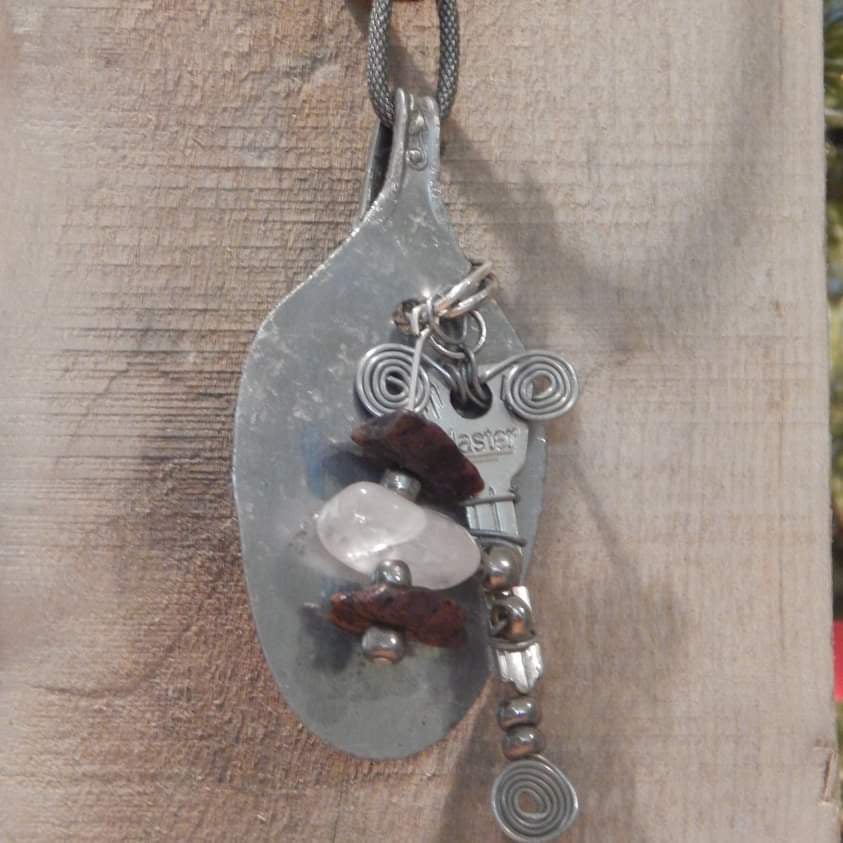Handmade pendant crafted from a hammered spoon, featuring stone bead charms and a wire-wrapped vintage key, by What in Narnation.