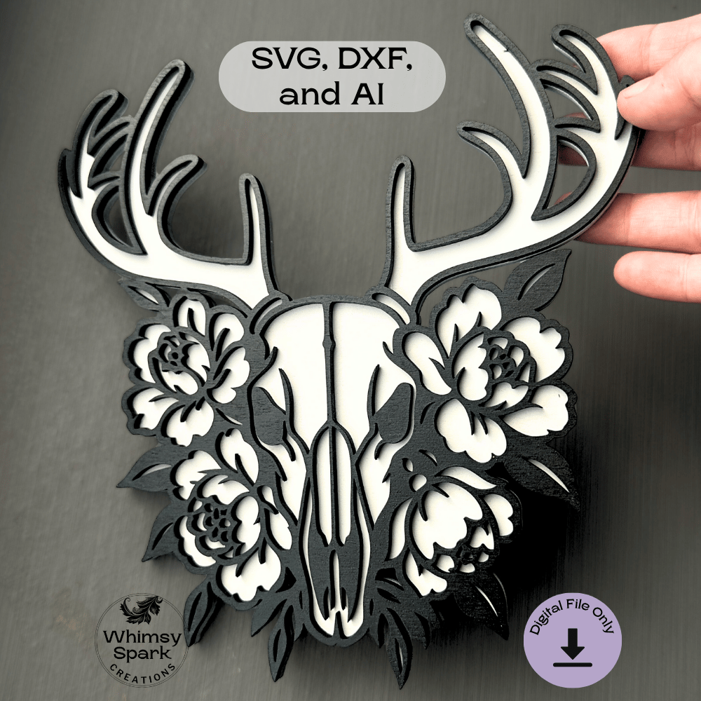 Layered deer skull with ornate antlers and blooming flowers in black and white, designed for laser cutting. Gothic boho wall art style, perfect for makers and crafters using Glowforge or Cricut.