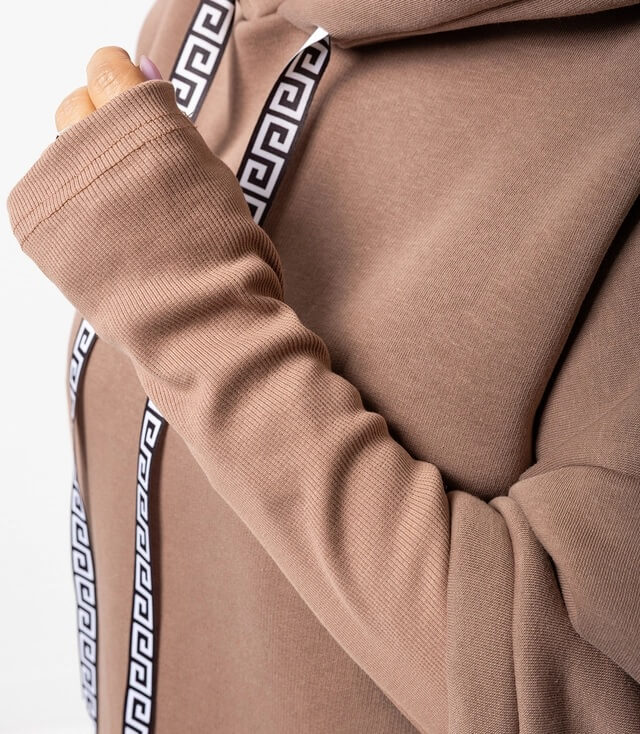 Beige Kapuzenpullover mit langen Ärmeln und Dekoband entlang der Seiten in Schwarz-Weiß.