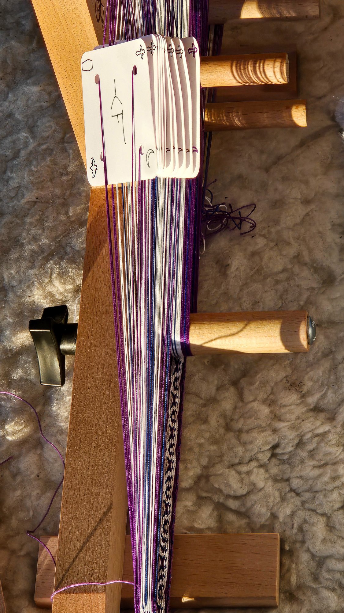 tablet weaving cards threaded on an inkle loom