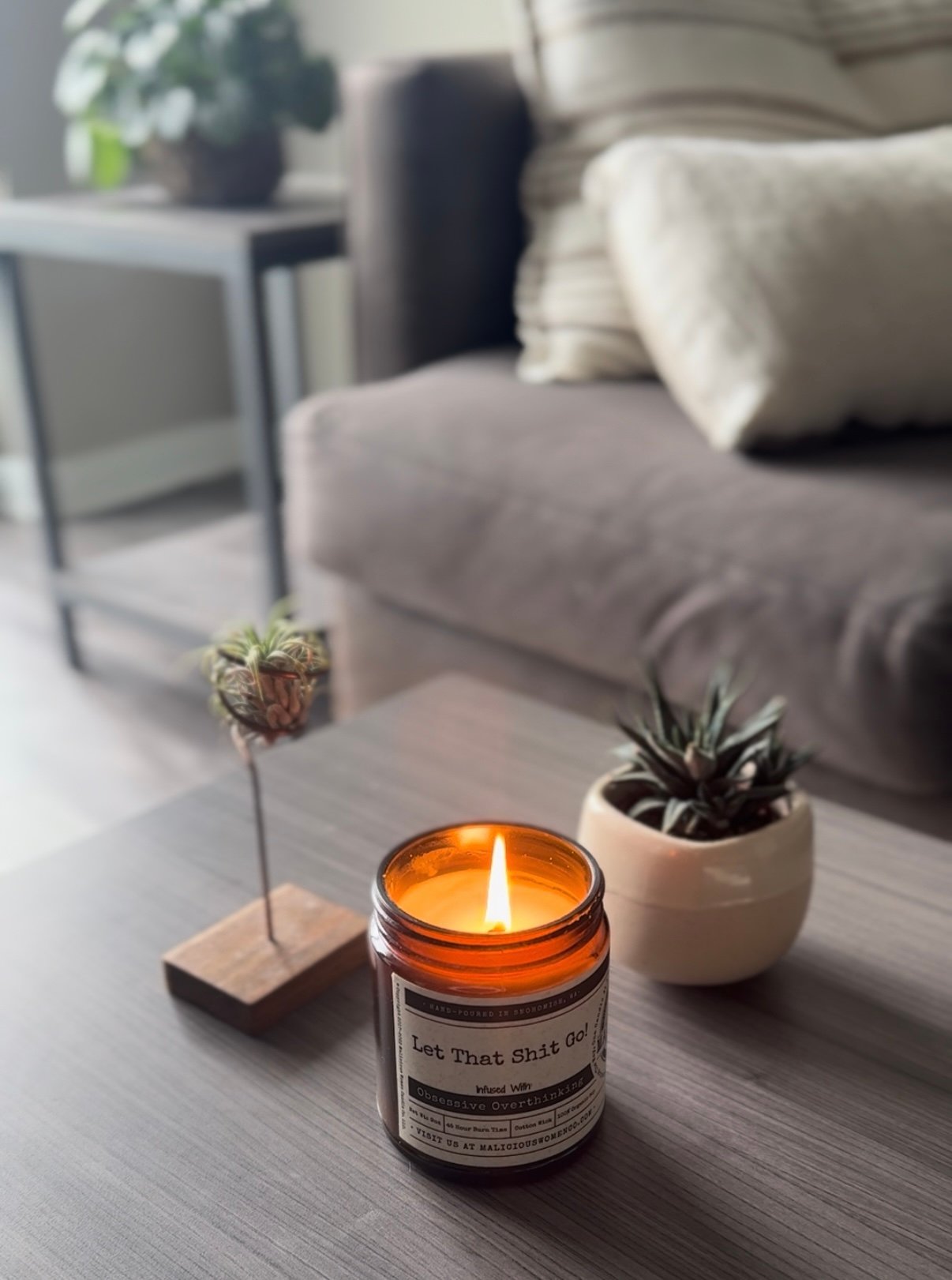 calming image of candle and plants in warm lighting